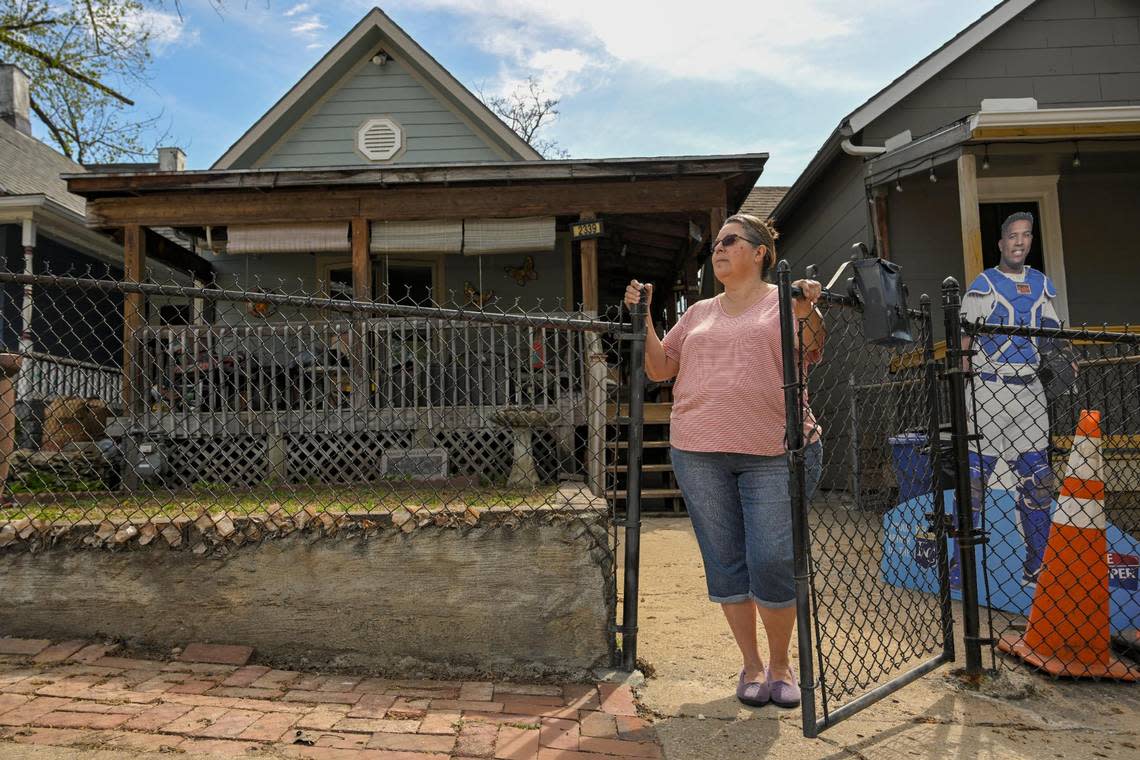 “If you want to be part of the neighborhood, then why the monstrosity?” said Rosario Coronado-Castaneda, 63, staring at the new home that towers above the bungalows in the 2300 block of Jarboe. Next to her is a cutout of Kansas City Royals catcher Salvador Perez.