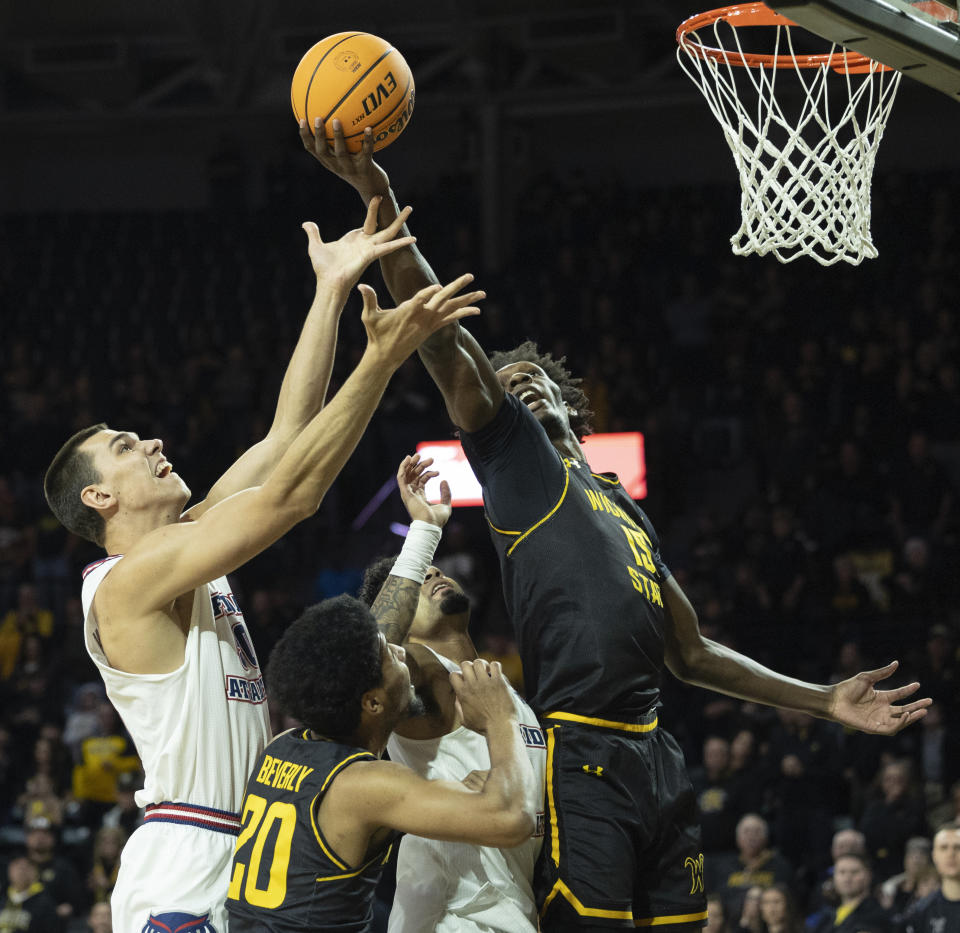 Wichita State's Quincy Ballard battles Florida Atlantic's Vladislav Goldin for a rebound during the first half of an NCAA college basketball game on Sunday, Feb., 11, 2024, in Wichita, Kan. (Travis Heying/The Wichita Eagle via AP)