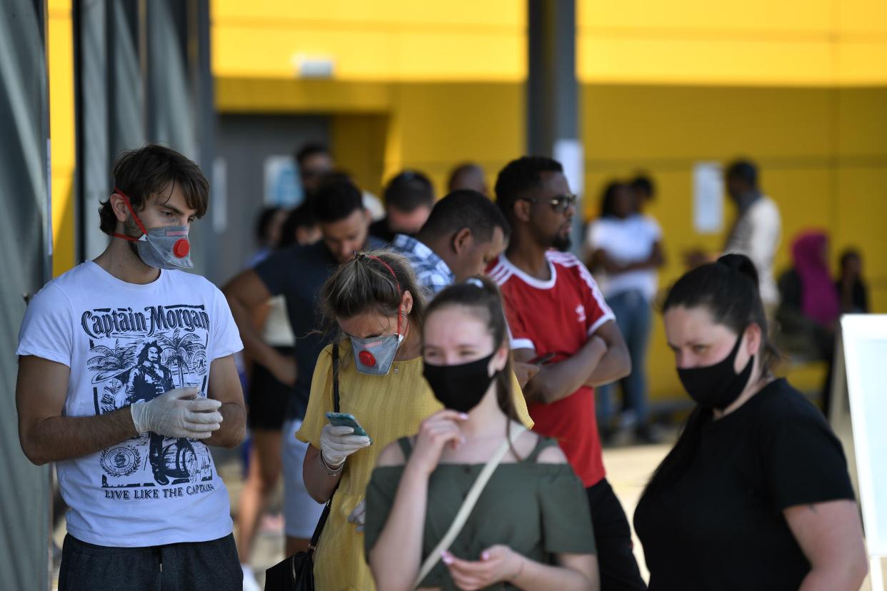 Members of the public wearing protective face masks queue outside an Ikea store at Wembley in north-west London as it re-opens its doors following the easing of the lockdown restrictions during the novel coronavirus COVID-19 pandemic on June 1, 2020. - Some non-essential stores, car dealerships and outdoor markets in Britain on June 1 were able to reopen from their COVID-19 shutdown in an easing of coronavirus lockdown measures. (Photo by DANIEL LEAL-OLIVAS / AFP) (Photo by DANIEL LEAL-OLIVAS/AFP via Getty Images)