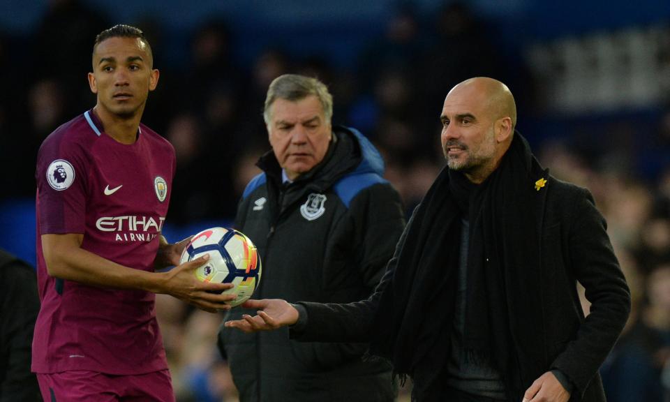 Pep Guardiola hands the ball to Danilo as the Everton manager, Sam Allardyce, looks on during Manchester City’s 3-1 win.