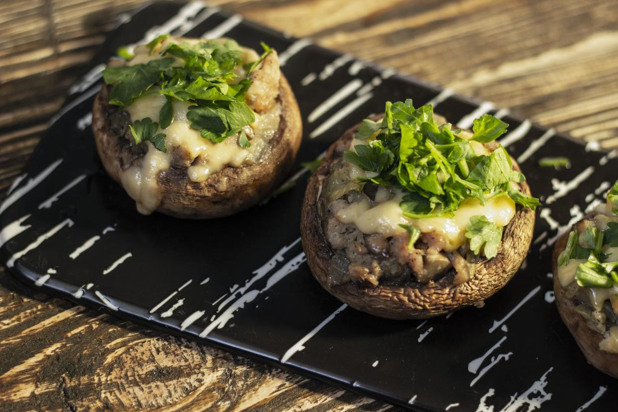 Stuffed mushrooms on a rough wooden surface