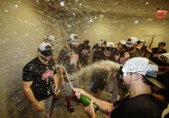 The Boston Red Sox celebrate after clinching the AL East title with an 11-6 win over the New York Yankees in a baseball game Thursday, Sept. 20, 2018, in New York. (AP Photo/Frank Franklin II)
