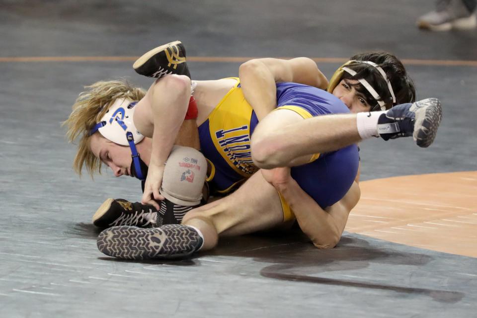 Cash Donnell of Piedmont, left, wrestles Evan Rodriguez of
Broken Arrow in a Class 6A 120-pound semifinal match during the Oklahoma state wrestling tournament at State Fair Arena in Oklahoma City, Friday, Feb. 24, 2023.