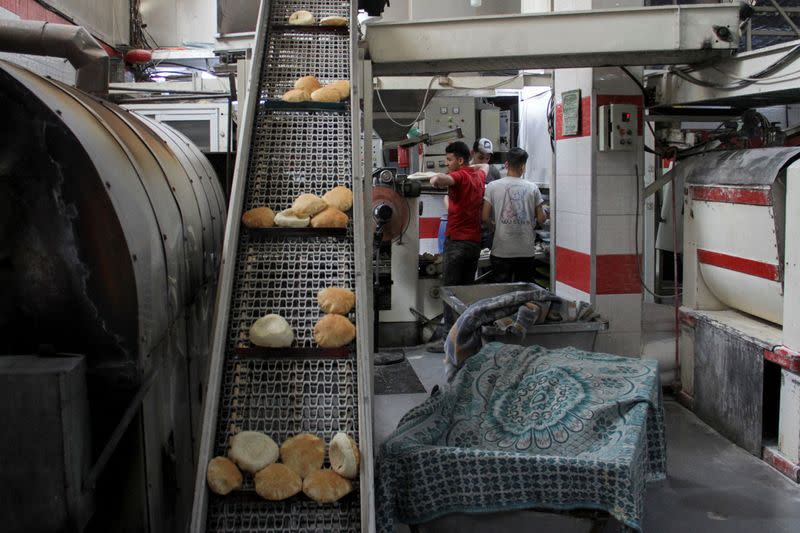 FILE PHOTO: Palestinians work at recently reopened Ajour bakery, amid the ongoing conflict between Israel and Hamas, in Gaza City