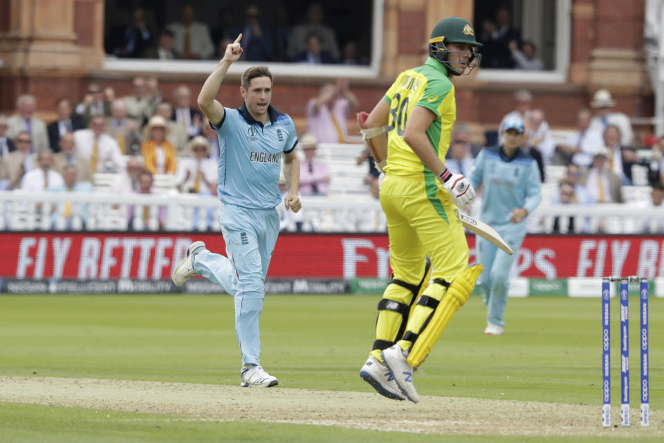 England's Chris Woakes celebrates taking the wicket of Australia's Pat Cummins during the Cricket World Cup match between England and Australia at Lord's cricket ground in London, Tuesday, June 25, 2019. (AP Photo/Matt Dunham)