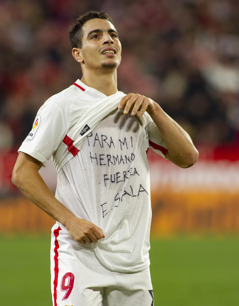 Sevilla's Ben Yedder shows a t-shirt reading 'To my brother, be strong, E. Sala' supporting Cardiff City FC's Argentinian forward Emiliano Sala, as celebrates after scoring during a Spanish Copa del Rey soccer match between Sevilla and FC Barcelona in Seville, Spain, Wednesday Jan. 23, 2019. (AP Photo/Miguel Morenatti)