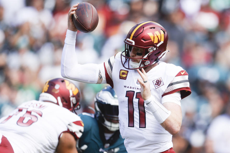 Washington Commanders quarterback Carson Wentz (11) fakes the pass during the first half of a NFL football game between the Washington Commanders and the Philadelphia Eagles on Sunday, Sept. 25, 2022 at FedExField in Landover, Md. (Shaban Athuman/Richmond Times-Dispatch via AP)