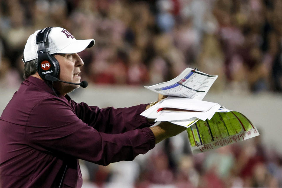 Oct 8, 2022; Tuscaloosa, Alabama; Texas A&M Aggies head coach Jimbo Fisher tries to call a timeout during the first half against the Alabama Crimson Tide at Bryant-Denny Stadium. Butch Dill-USA TODAY Sports