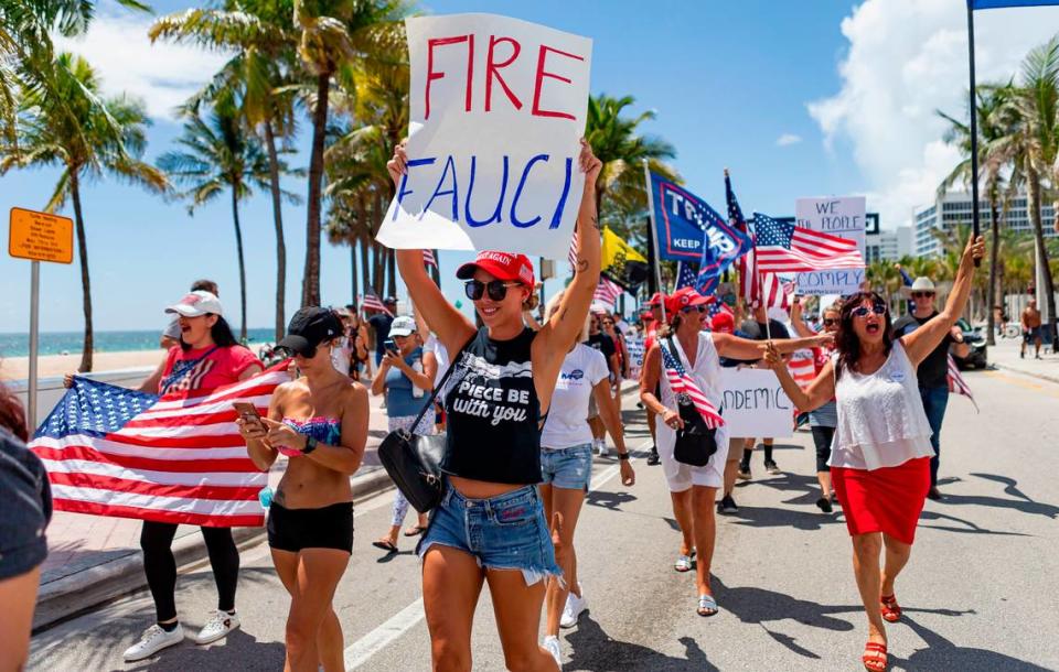 Kier Mellour, center, participates in an ÒEnd Of The Pandemic March South FloridaÓ rally in Las Olas Beach in Fort Lauderdale, Florida on Saturday, August 15, 2020.