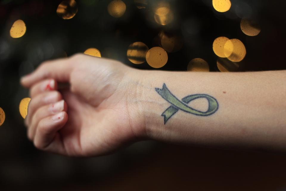 Reagan Devlin shows the organ donation ribbon tattoo she received two years ago.