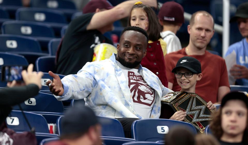 WWE wrestling star and former champion Big E poses for a picture with fan Christopher Trent, 10, of Lincoln Park as his uncle William Blair, 50, also of Lincoln Park, takes a picture of them with his iPhone towards the end of the Michigan Panthers' game at Ford Field in Detroit on Saturday, May 13, 2023. The Pittsburgh Maulers beat the Panthers, 23-7.