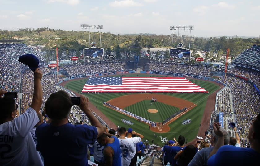 LOS ANGELES-CA-APRIL 12, 2016: An America flag covers the field during the national anthem at Dodger Stadium on Opening Day. (Christina House / For The Times)