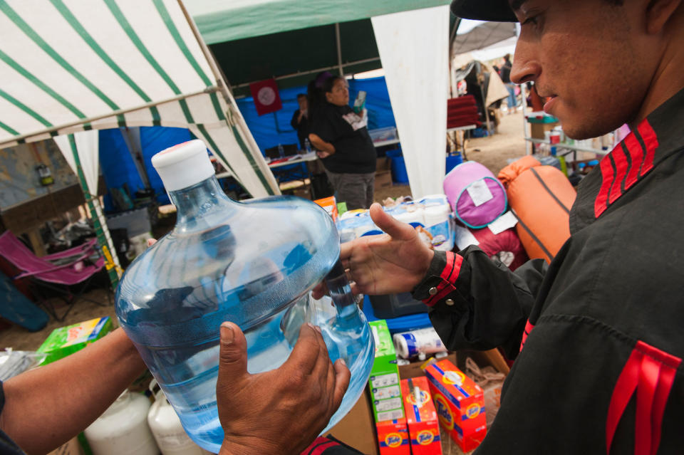 <p>Volunteers pass out water and other items during a protest against the construction of the Energy Transfer Partners Dakota Access oil pipeline near the Standing Rock Sioux reservation in Cannon Ball, N.D., on Sept. 5, 2016. (Photo: Andrew Cullen/Reuters) </p>