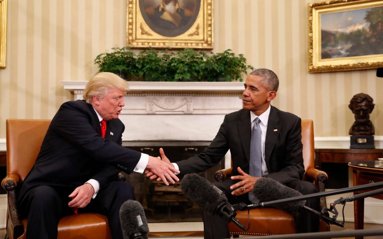 President Barack Obama shakes hands with President-elect Donald Trump in the Oval Office of the White House in Washington - AP