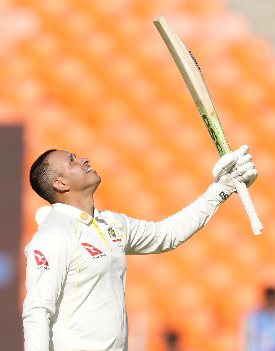 Australia's Usman Khawaja looks up as he raises his bat to celebrate scoring a century during the first day of the fourth cricket test match between India and Australia in Ahmedabad, India, Thursday, March 9, 2023. (AP Photo/Ajit Solanki)