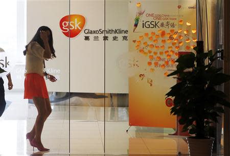 An employee walks inside a GlaxoSmithKline (GSK) office in Shanghai, in this file picture taken July 16, 2013. REUTERS/Stringer