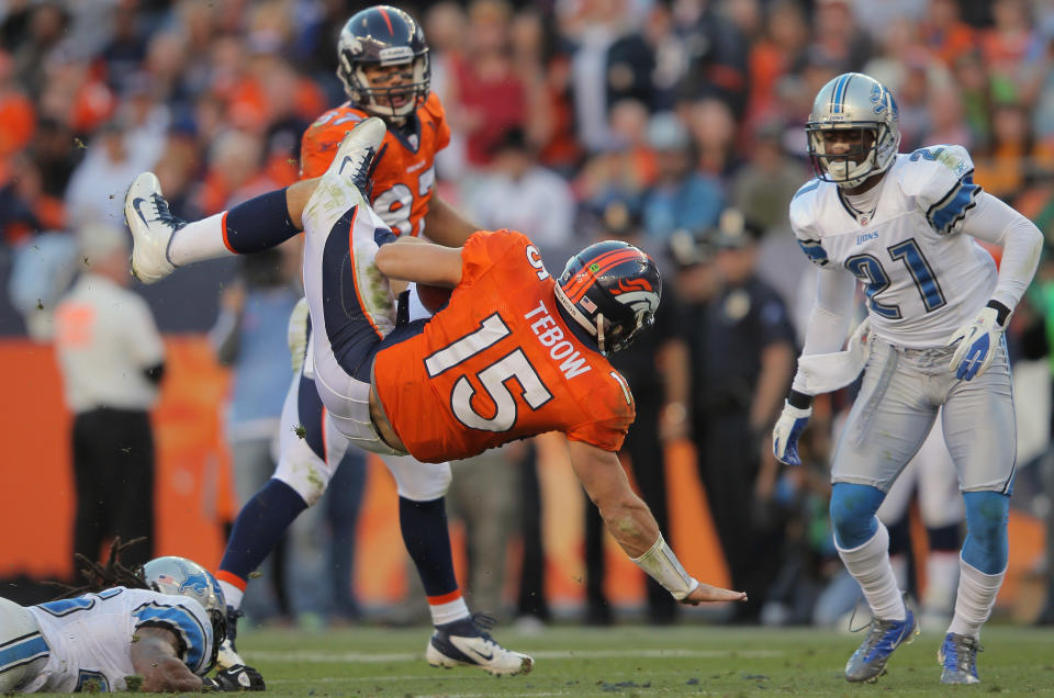 DENVER, CO - OCTOBER 30: Quarterback Tim Tebow #15 of the Denver Broncos is upended by Louis Delmas #26 of the Detroit Lions as he scrambles at Sports Authority at Invesco Field at Mile High on October 30, 2011 in Denver, Colorado. (Photo by Doug Pensinger/Getty Images)