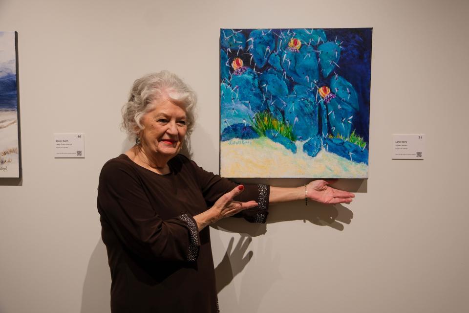 Lanell Berry stands by her painting "Flower Garden" at the 20x20 Art Exhibition and Silent Auction at the Amarillo Museum of Art on the campus of Amarillo College.