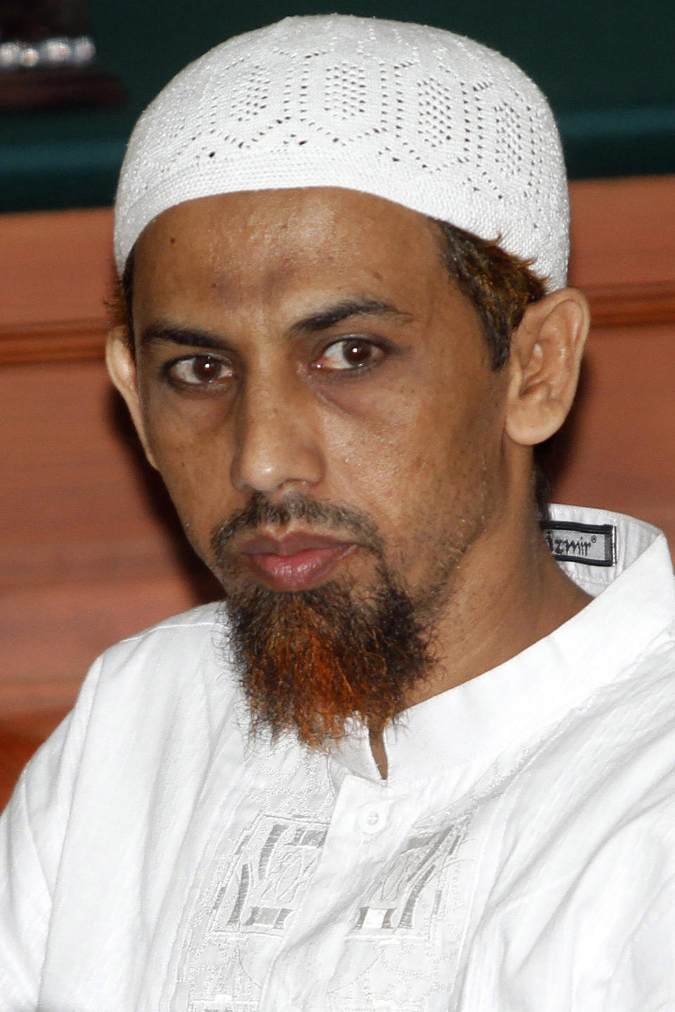 FILE - Indonesian Muslim militant Umar Patek looks on during his trial in Jakarta, Indonesia, Thursday, March 8, 2012. A bombmaker in the 2002 Bali attack that killed 202 people has walked free from an Indonesian prison Wednesday, Dec. 7, 2022 after serving half of a 20-year sentence, despite upsetting Australia’s leader who described him as “abhorrent.” Umar Patek, 55, whose real name is Hisyam bin Alizein, was a leading member of the al Qaida-linked network Jemaah Islamiyah. (AP Photo/Tatan Syuflana, File)