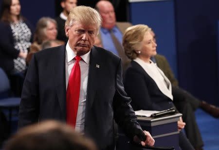 Republican U.S. presidential nominee Donald Trump and Democratic U.S. presidential nominee Hillary Clinton pause during their presidential town hall debate at Washington University in St. Louis, Missouri, U.S., October 9, 2016. REUTERS/Rick Wilking