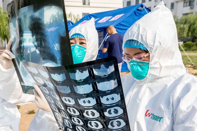 Health workers act in an exercise dealing with an outbreak of H7N9 avian flu in June in Hebi, China. Source: Getty