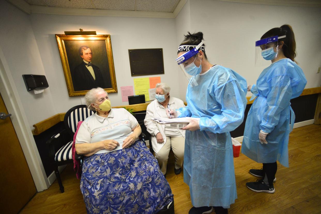 Kathleen Sawtelle, a pharmacist with Health Direct, gives the Pfizer's COVID-19 vaccine to Rebecca McKenny, a resident of Thompson House Rehabilitation & Nursing Center, in Brattleboro, Vt. on Tuesday, Dec. 29, 2020.