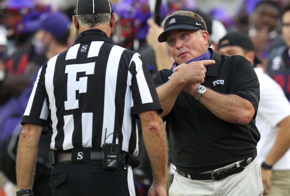 TCU head coach Gary Patterson, right, talks with an official during an NCAA college football game against Kansas State, Saturday, Oct. 10, 2020, in Fort Worth, Texas. (AP Photo/Richard W. Rodriguez)