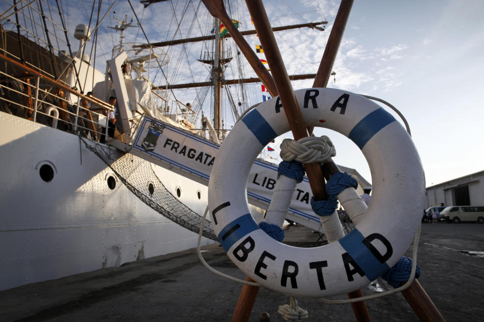 The three-masted ARA Libertad, a symbol of Argentina's navy, sits docked at the port in Tema, outside Accra, Ghana, Saturday, Oct. 20, 2012. Argentina announced the immediate evacuation Saturday of about 300 crew members from the Libertad, a navy training ship seized in Africa nearly three weeks ago as collateral for unpaid bonds dating from the South American nation's economic crisis a decade ago.(AP Photo/Gabriela Barnuevo)