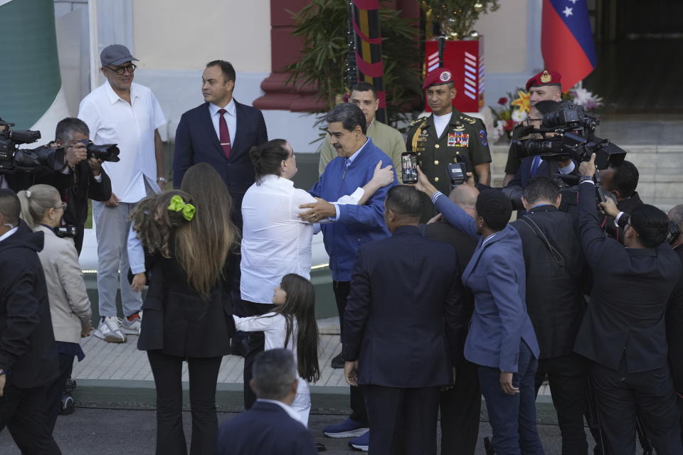 Venezuelan President Maduro, center right, embraces Alex Saab at Miraflores presidential palace in Caracas, Venezuela, Wednesday, Dec. 20, 2023. The United States freed Saab, who was arrested on a U.S. warrant for money laundering in 2020, in exchange for the release of 10 Americans imprisoned in Venezuela, U.S. officials said Wednesday. (AP Photo/Matias Delacroix)