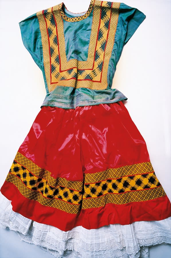 A traditional Tehuana dress, the full skirt was one of many features Kahlo strategically employed to cover up her handicaps.