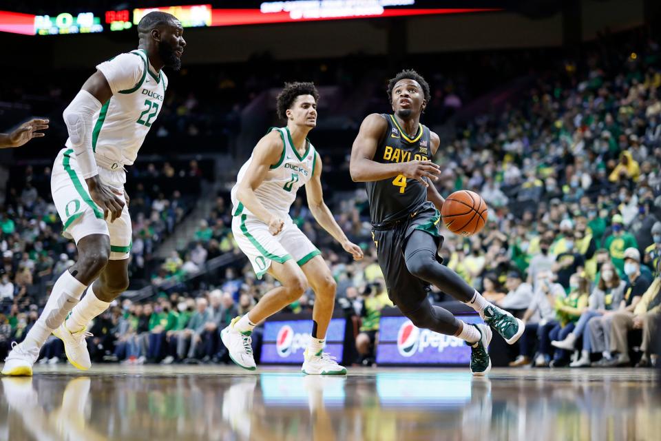 Baylor guard LJ Cryer (4) drives to the basket past Oregon guard Will Richardson (0) during the second half at Matthew Knight Arena.