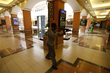 An armed police searches through a shopping centre for gunmen in Nairobi, September 21, 2013. REUTERS/Goran Tomasevic