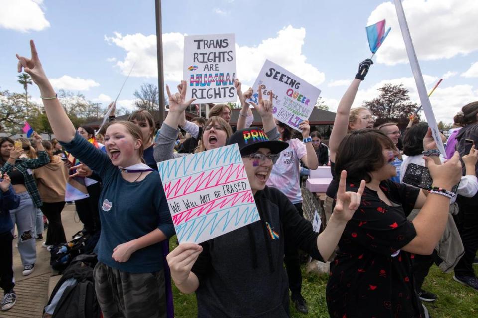 Oakmont High School students Jeane Nelson and Alexis Garber show their support during a school walkout in Roseville on Friday to protest the Roseville Joint Union High School District’s decision to cut ties with a local LGBTQ group. About 100 supporters attended the rally outside of the district offices.