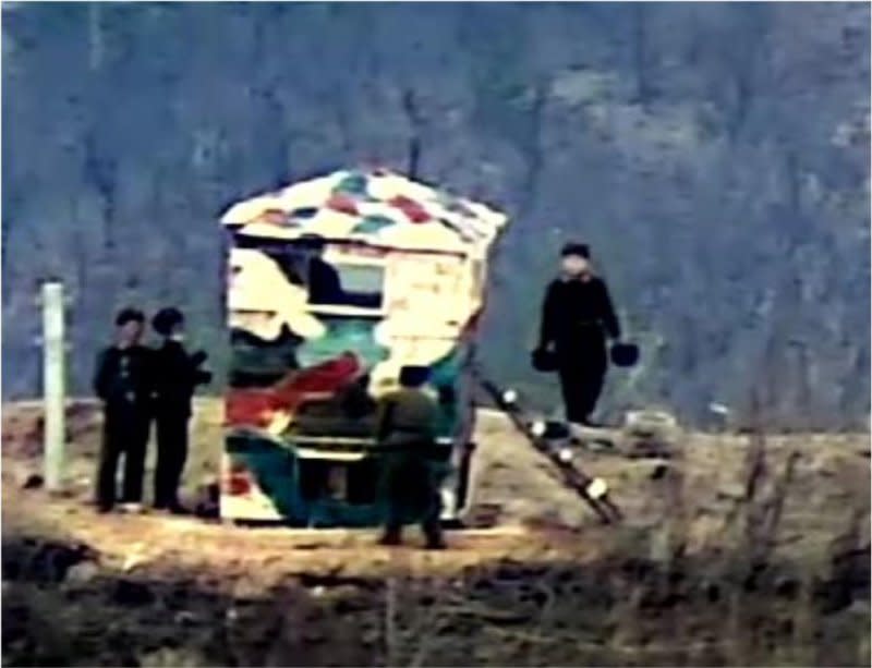 North Korean soldiers are spotted painting a guard post inside the Demilitarized Zone separating the two Koreas on Friday. Photo courtesy of South Korean Defense Ministry/Yonhap