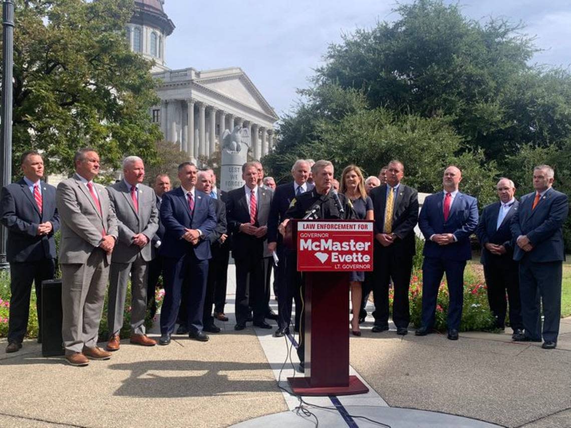 Richland County Sheriff Leon Lott, center, a Democrat, endorses Republican Gov. Henry McMaster’s 2022 reelection bid outside the S.C. State House on Wednesday, Sept. 28, 2022.