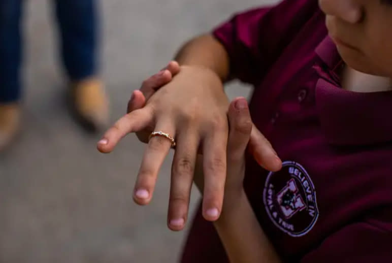 Zayin Zuniga shows his ring that matches the one he left at Ellie Garcia’s memorial. (Kaylee Greenlee Beal/The Texas Tribune)