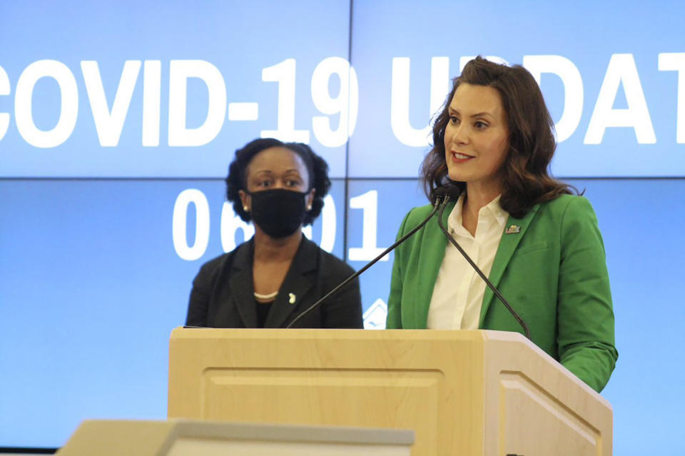 In this Monday, June 1, 2020, photo provided by the Michigan Office of the Governor, Michigan Gov. Gretchen Whitmer speaks during a news conference in Lansing, Mich. Whitmer lifted Michigan's nearly 10-week coronavirus stay-at-home order Monday, letting restaurants reopen to dine-in customers next week and immediately easing limits on outdoor gatherings while keeping social-distancing rules intact. (Michigan Office of the Governor via AP, Pool)