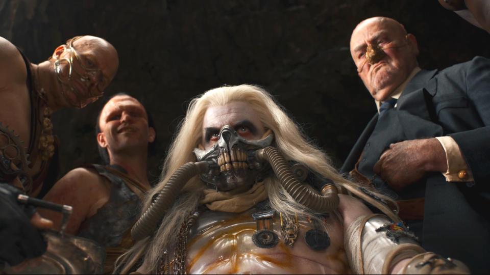 Immortan Joe surrounded by his cronies in Furiosa: A Mad Max Saga.