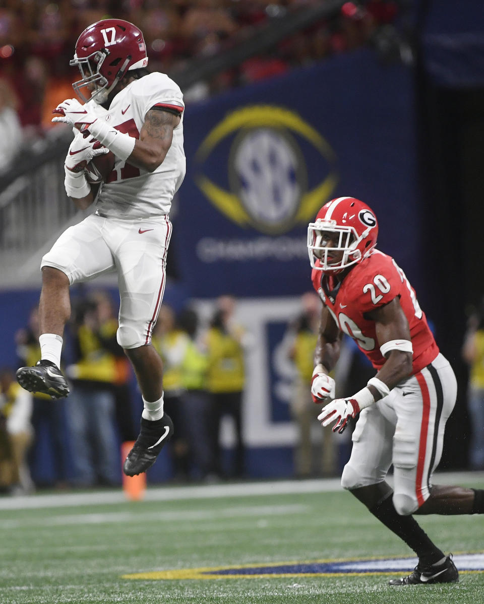 Alabama wide receiver Jaylen Waddle (17) makes a catch against Georgia defensive back J.R. Reed (20) during the second half of the Southeastern Conference championship NCAA college football game, Saturday, Dec. 1, 2018, in Atlanta. (AP Photo/John Amis)