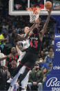 Toronto Raptors forward Pascal Siakam (43) shoots against Dallas Mavericks center Kristaps Porzingis (6) and forward Dorian Finney-Smith (10) during the first half of an NBA basketball game in Dallas, Wednesday, Jan. 19, 2022. (AP Photo/LM Otero)