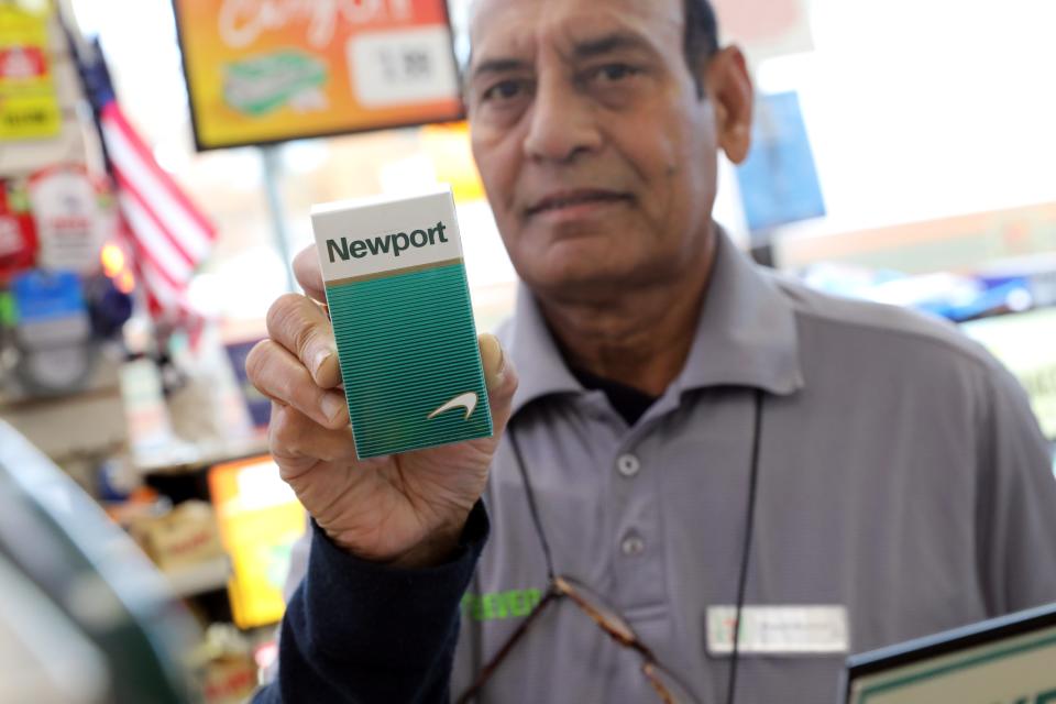 Pravinkumar Patel holds a pack of Newport cigarettes, one of the brand of menthol cigarettes they sell at 7-Eleven in Tarrytown, Nov. 28, 2022. A proposed ban will stop the sale of menthol cigarettes in Westchester County.