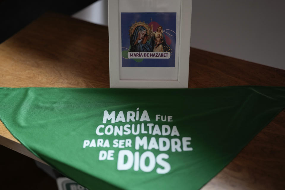 A green scarf with a message that reads in Spanish: “Mary was consulted to be mother of God” is spread out on a table in the office of the Catholics for the Right to Decide, in Mexico City, Monday, Dec. 4, 2023. For these Catholic women, prayer does not conflict with their fight for abortion access nor does their devotion to Our Lady of Guadalupe prevent them from supporting LGBTQ+ rights. (AP Photo/Eduardo Verdugo)