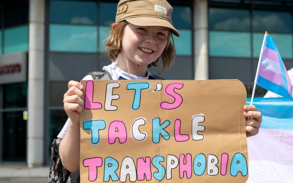 A protestor outside Twickenham Stadium referring to a ban on transgender women playing rugby - Belinda Jiao