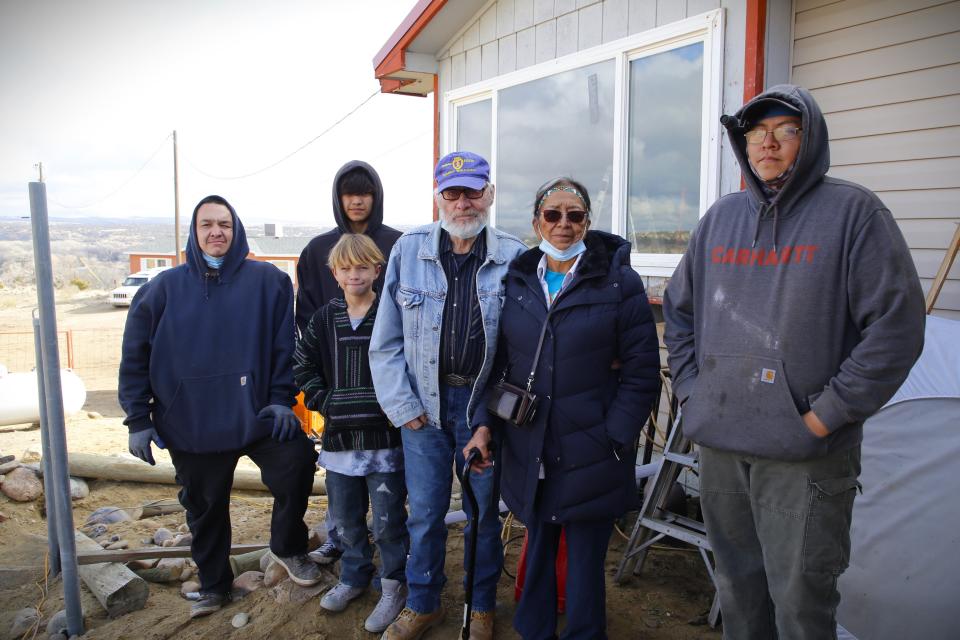 Dakota Green, left, Ladanian Tsosie, Caiden Davidson, Larry Green, Phyllis Green and Chandler Sandoval stand outside the family's home near Aztec that was severely damaged in a Dec. 11 fire.