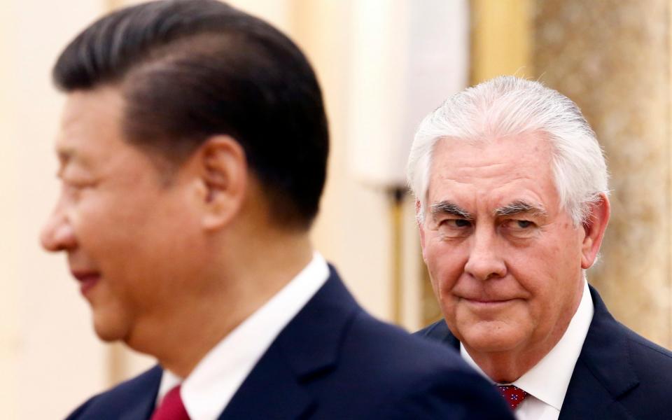 China's President Xi Jinping, left, stands near U.S. State of Secretary Rex Tillerson during a meeting at the Great Hall of the People in Beijing, China. - Credit: Reuters