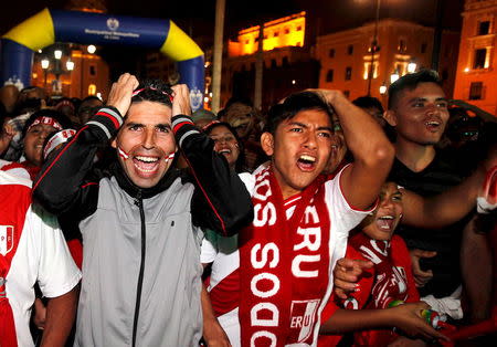 Peruvian fans react while watching the Copa America semi-final soccer match between Peru and Chile played in Santiago, Chile, at the Main square in down town Lima, Peru, June 29, 2015. REUTERS/Paco Chuquiure