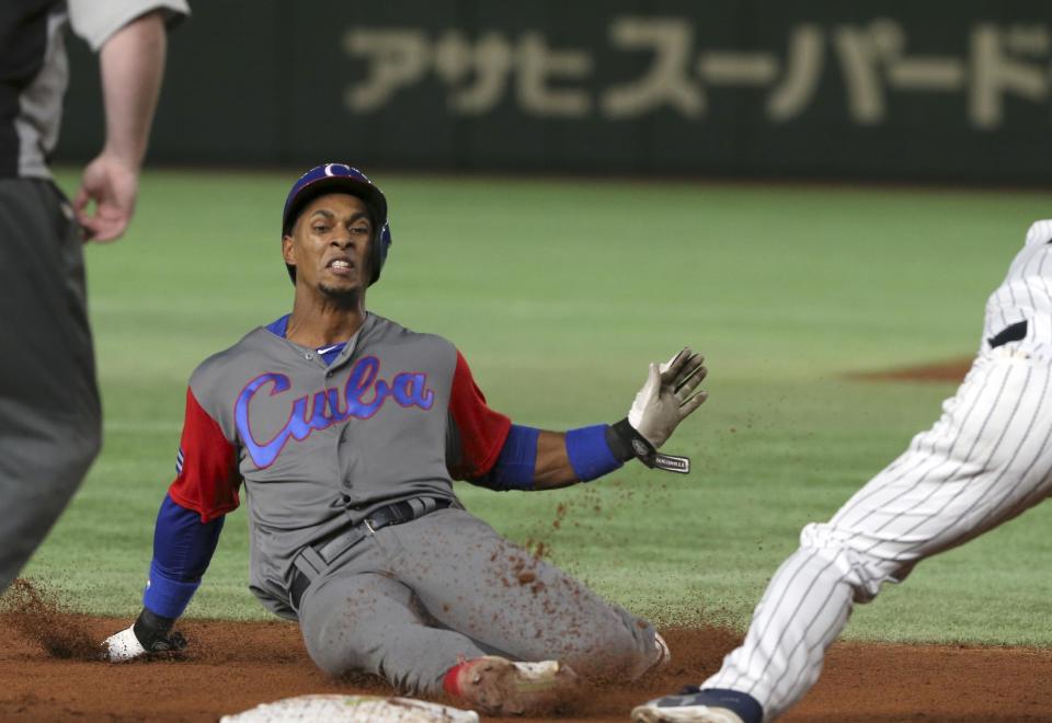 Cuba's Yurisbel Gracial tags up to third safely during the sixth inning of their second round game against Japan at the World Baseball Classic at Tokyo Dome in Tokyo, Tuesday, March 14, 2017.(AP Photo/Toru Takahashi)