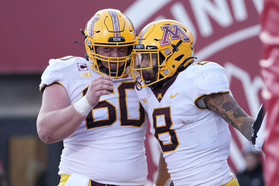 Minnesota running back Ky Thomas (8) is congratulated by teammate John Michael Schmitz (60) after scoring a touchdown against Indiana in the first half during an NCAA college football game in Bloomington, Ind., Saturday, Nov. 20, 2021. (AP Photo/AJ Mast)