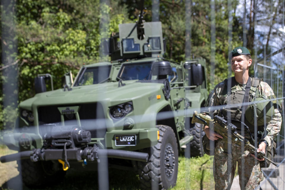 Soldiers stand guard at a fence surrounding the venue of the NATO summit in Vilnius, Lithuania, Sunday, July 9, 2023. Russia's war on Ukraine will top the agenda when U.S. President Joe Biden and his NATO counterparts meet in the Lithuanian capital Vilnius on Tuesday and Wednesday. (AP Photo/Mindaugas Kulbis)