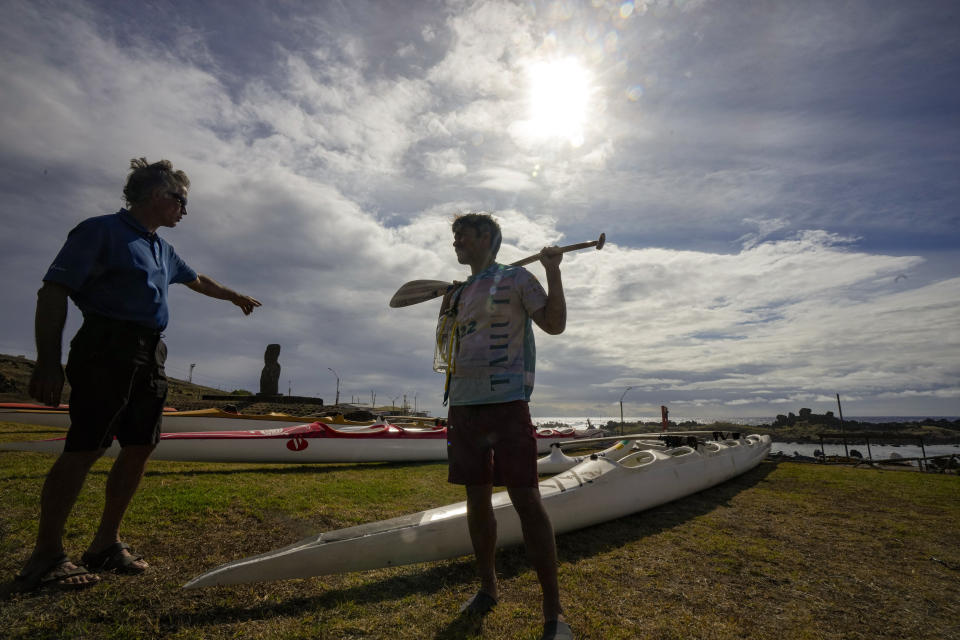 Rapanui Konturi Atan, a 36-year-old historian, right, receives instructions from Gilles Bordes, at the start of a training session for the Hoki Mai challenge, a canoe voyage — covering almost 500 kilometers, or about 300 miles across a stretch of the Pacific Ocean, in Rapa Nui, a territory that is part of Chile and is better known as Easter Island, Thursday, Nov. 24, 2022. Bordes, coordinator of Hoki Mai, moved to Rapa Nui earlier this year, but he has lived in Polynesia for three decades, devoting much of his time to rowing. (AP Photo/Esteban Felix)